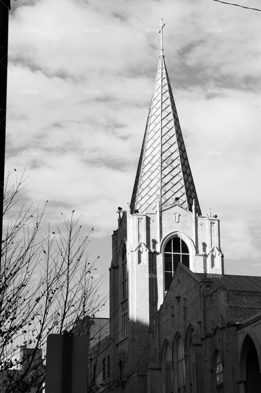Church spire in black & white. Photo taken in downtown Tulsa.  Church spire with texture and cross.