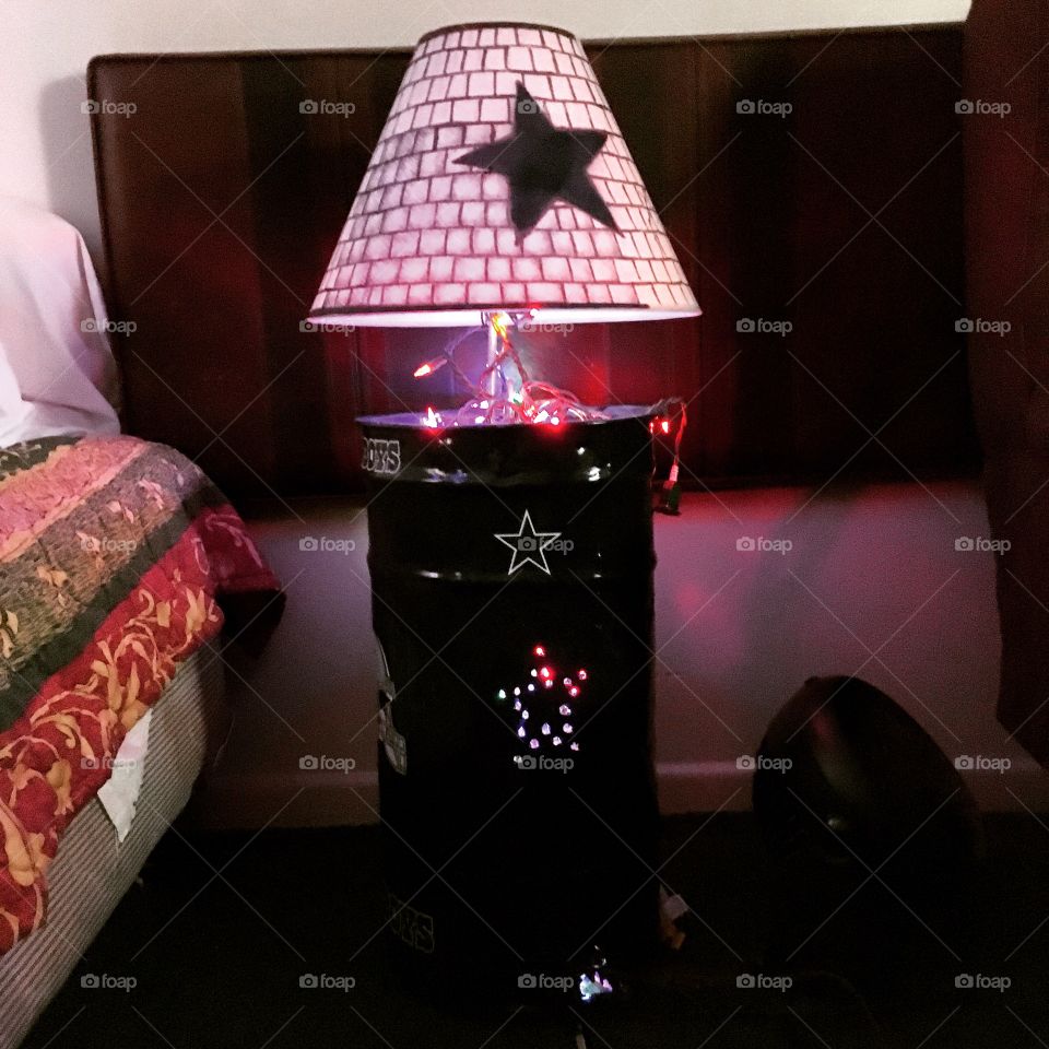I made this lamp out of a old trash can and used a dark blue rust olem paint and bought the lampshade and decorated it with a pen 