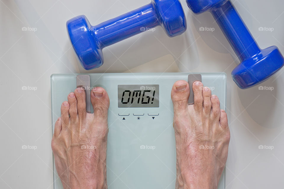 Man standing on scale. Losing weight.