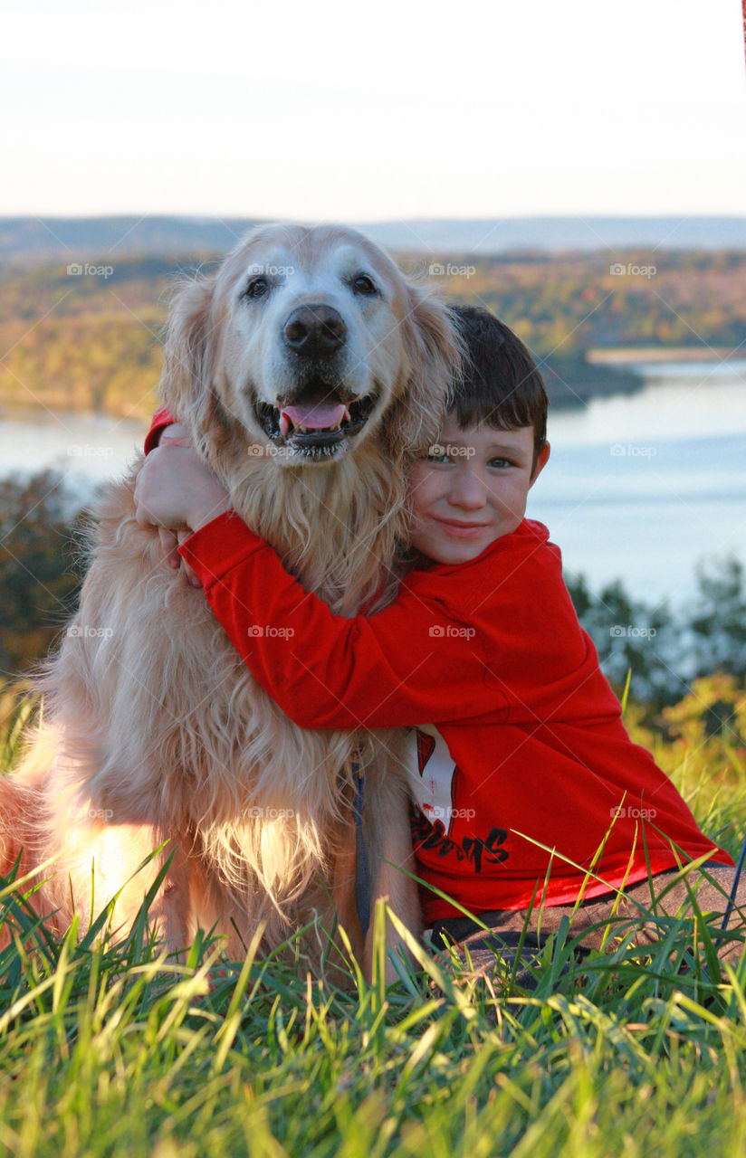 Portrait of boy hugging his pet