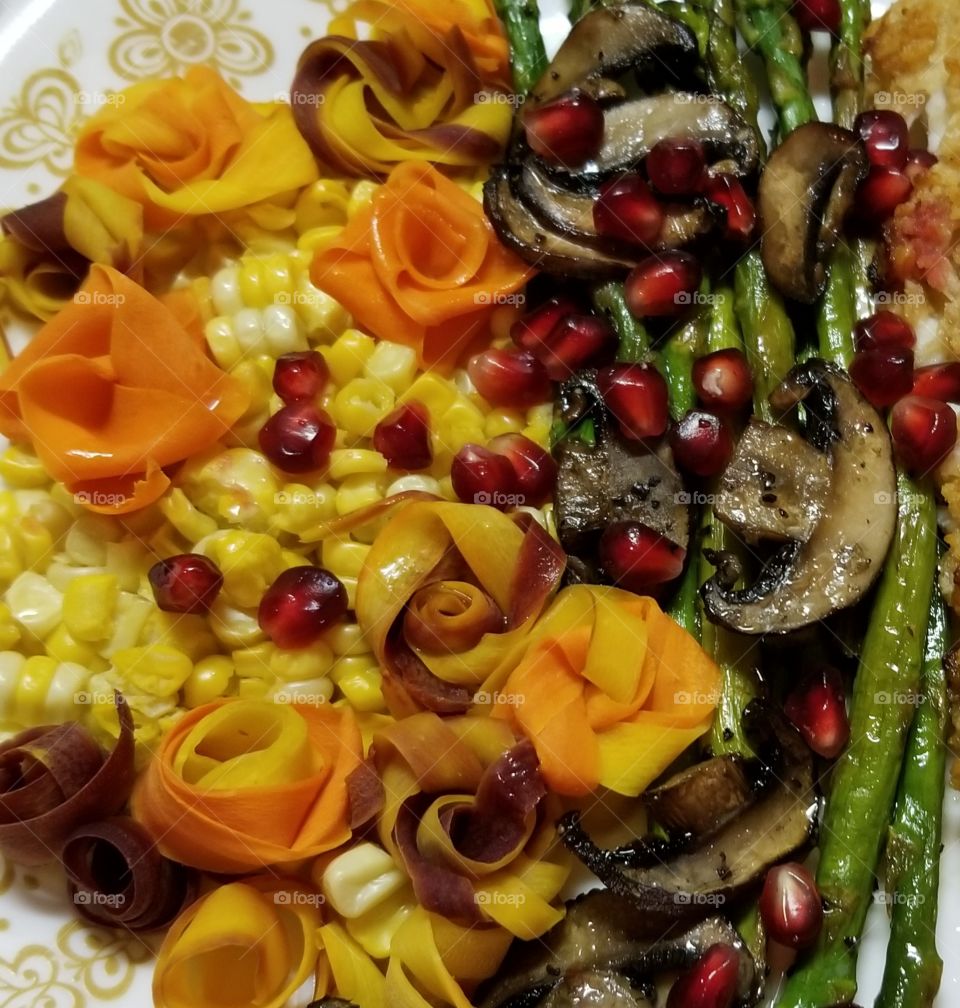 Harvest veggie plate - a rainbow of naturally healthy and flavorful specimens of nature's bounty. Asparagus, oven roasted with mushrooms and garlic. Fresh bi-color corn, multi-colored carrot slices twisted into roses, and pomagranate arills.