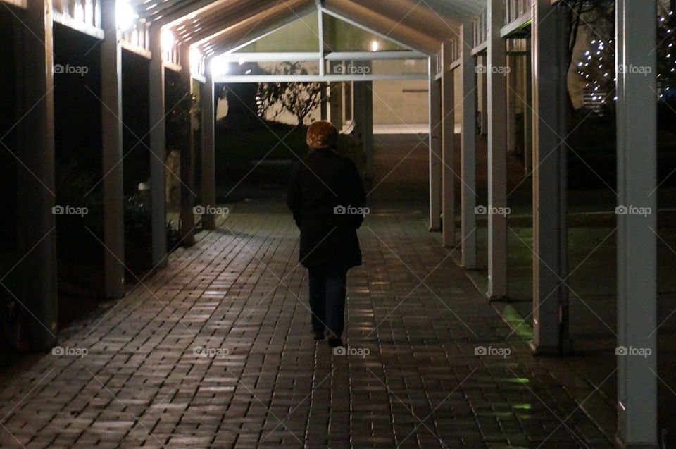 woman walking through a corridor