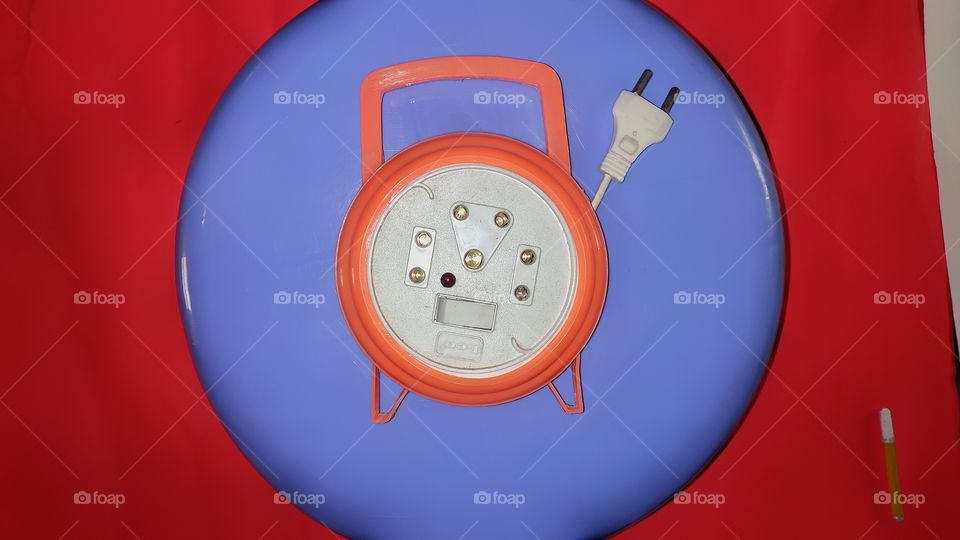 extension board on blue board with orange background.