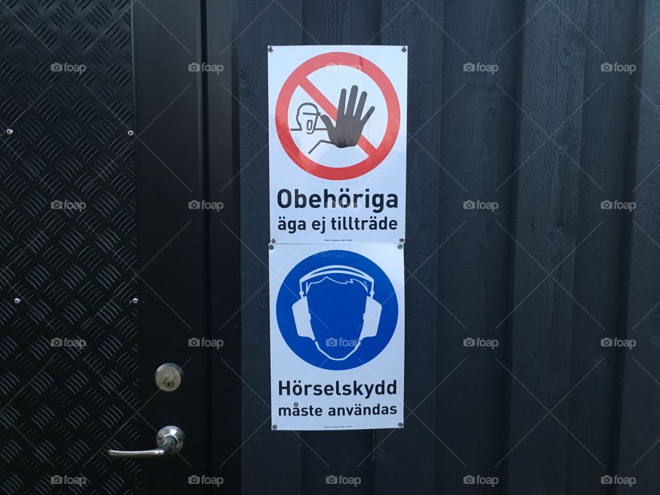 Hazard signs on a small black shed in Sweden
