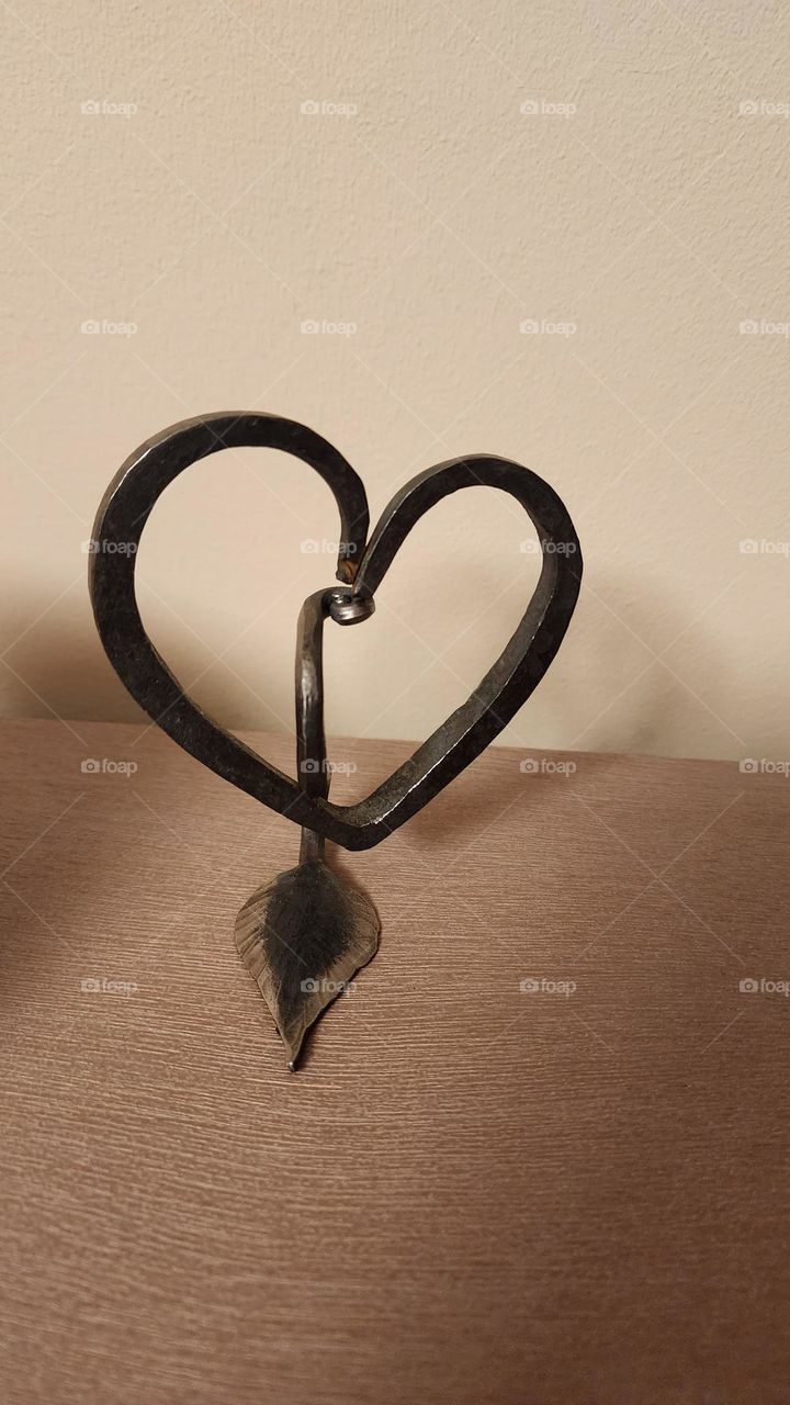 A heart and leaf formed through blacksmithing.