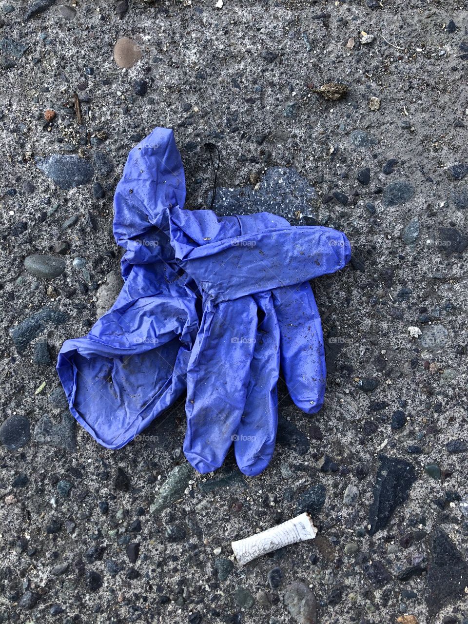 dirty surgical gloves discarded on the street floor, dirty public space,