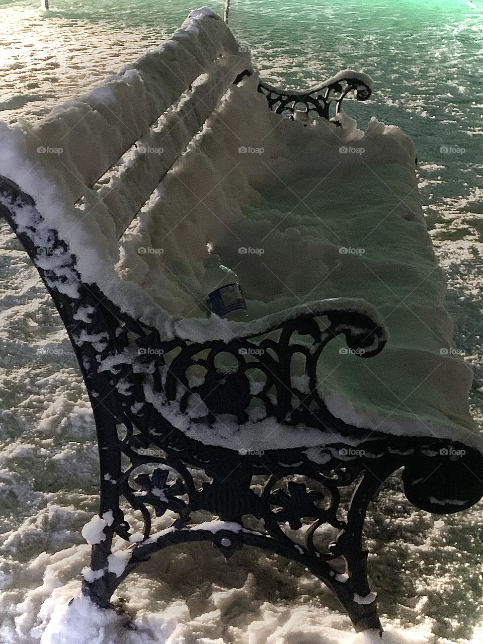 Snow covered bench at night