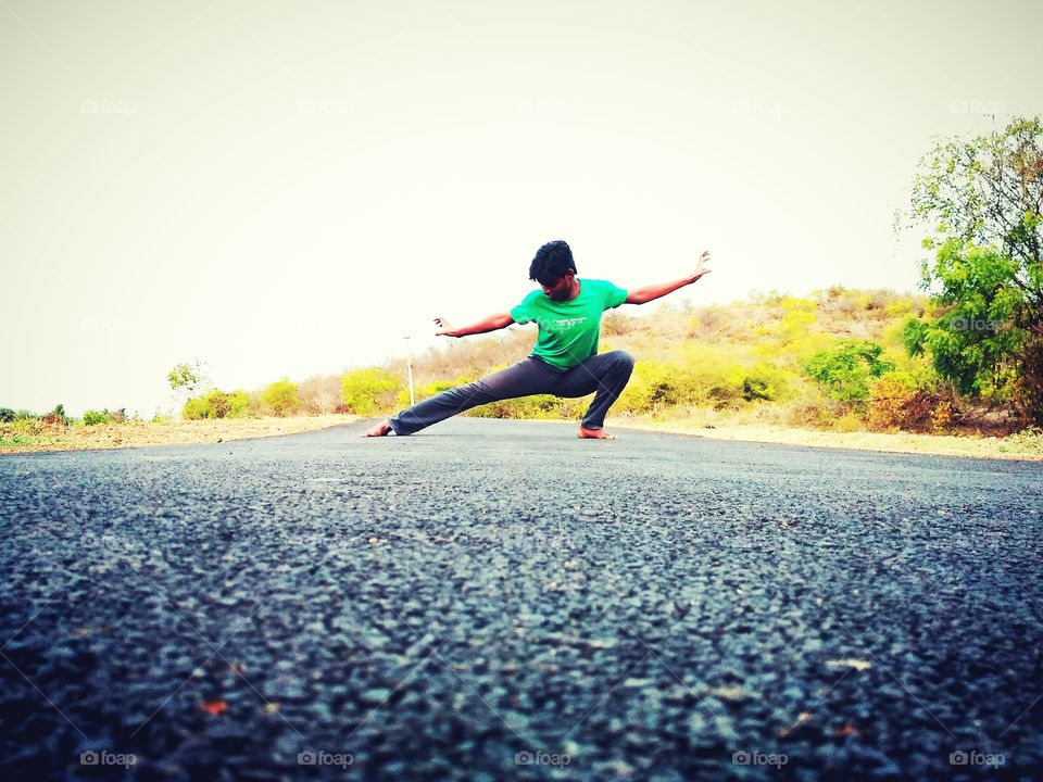 Young man exercising on empty road