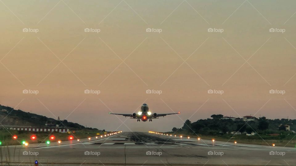 Standing at the end of the runway at “golden hour” and capturing this aeroplane as it lifts off the runway during take off.