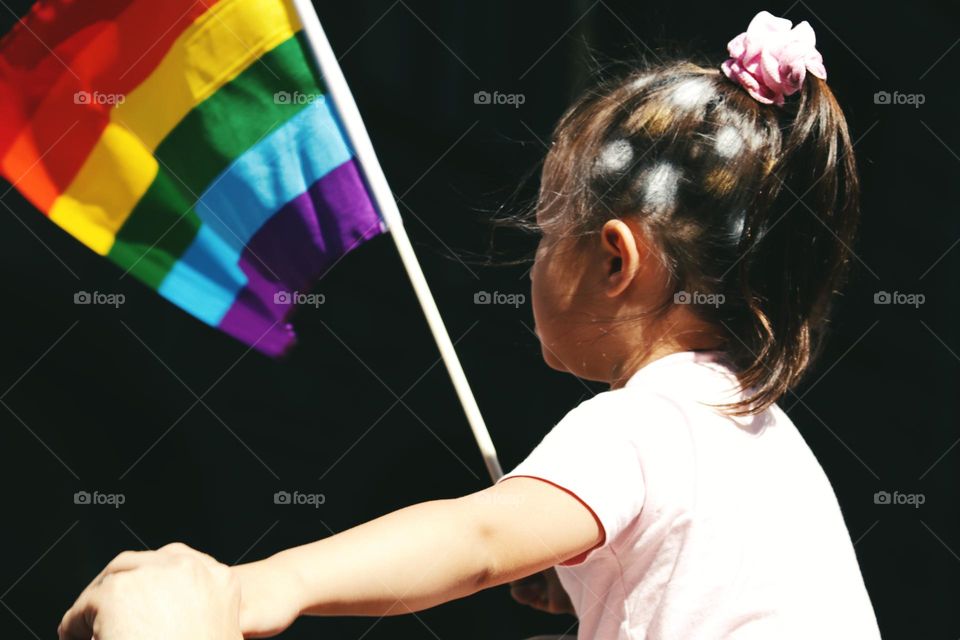 Beautiful little girl waving angry flag 