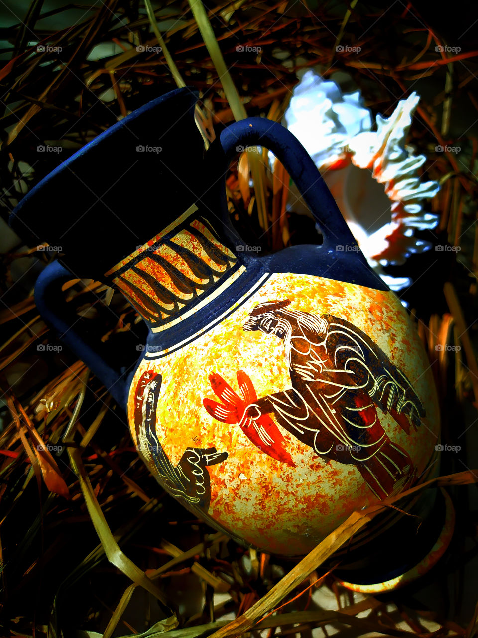 Greek amphora and seashell on brown sawdust