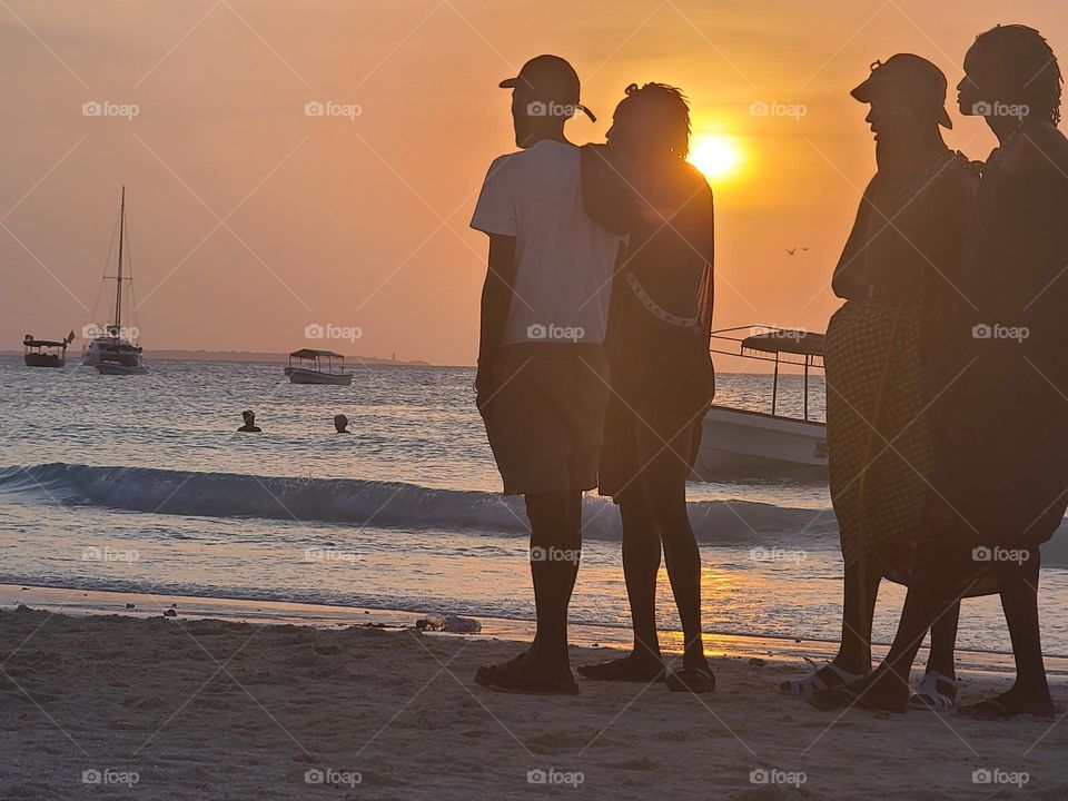 Silhouettes of people on the beach in Zanzibar