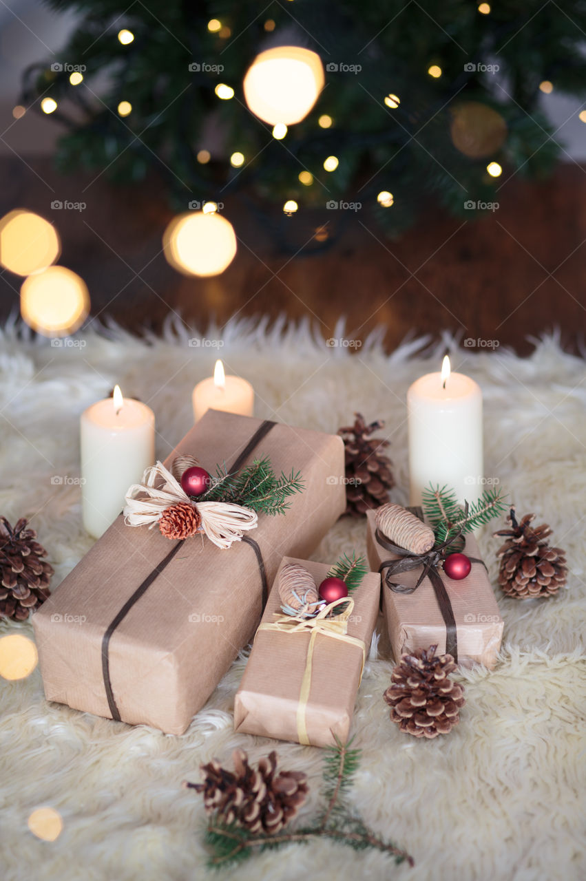 Gift box and candles on table