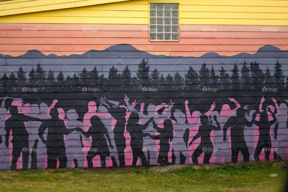 Colourful artwork is on full display on the side of a building in a nearby village known for its vibrant public art.  