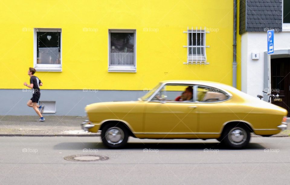 old yellow car in front of a house