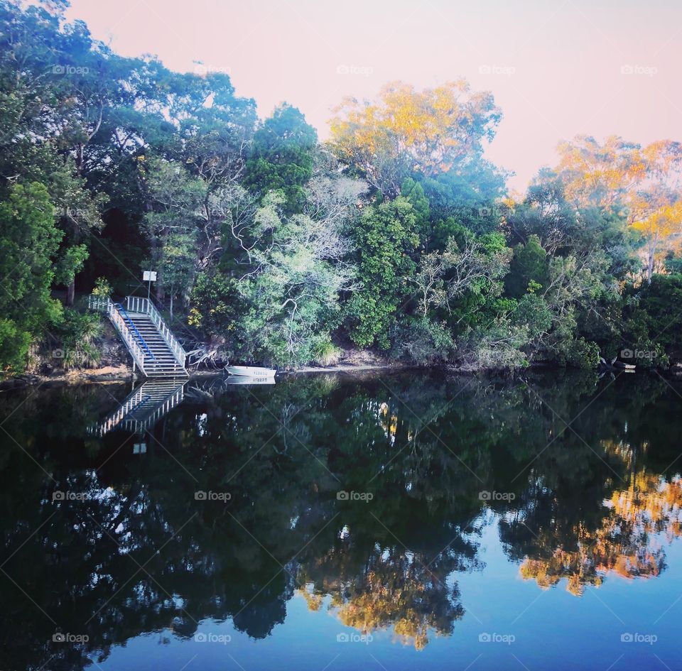 Beautiful reflections on the lake staircase to the water 
