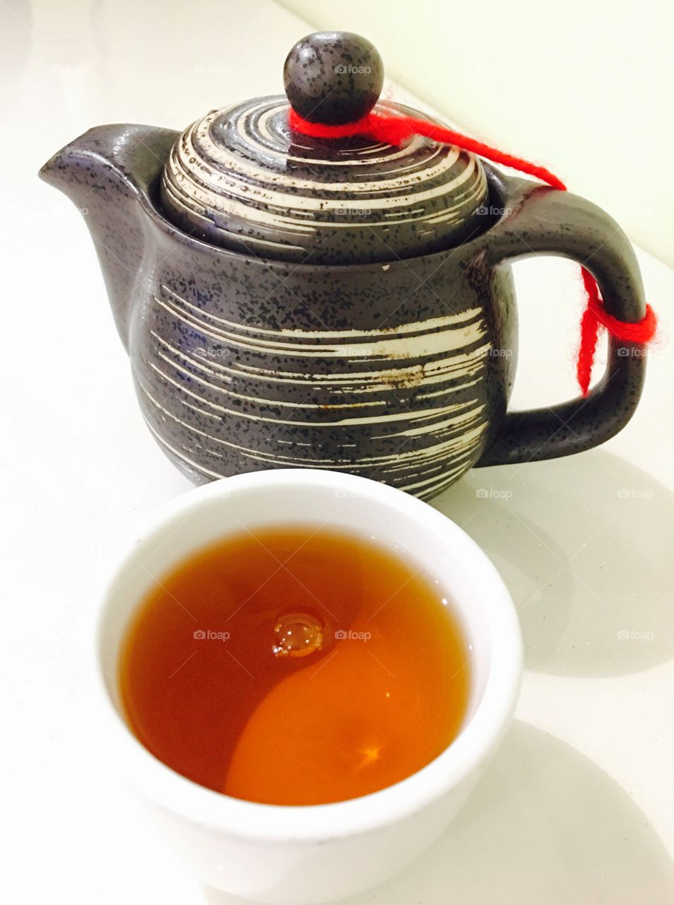 Herbal tea in cup with teapot