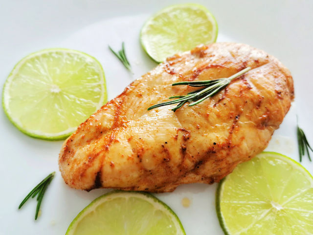 Grilled Chicken on a white plate.  Concept for weight loss program, healthy food and ketogenic diet plan.