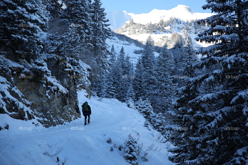 Man climbing snowy mountain
