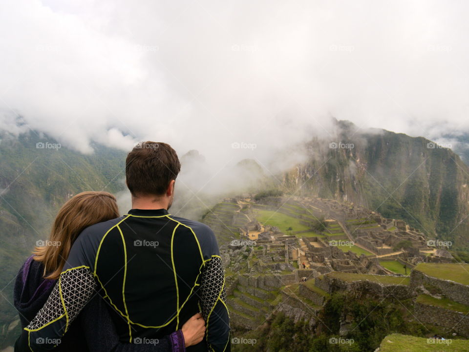 A couple enjoying their view over Machu Picchu