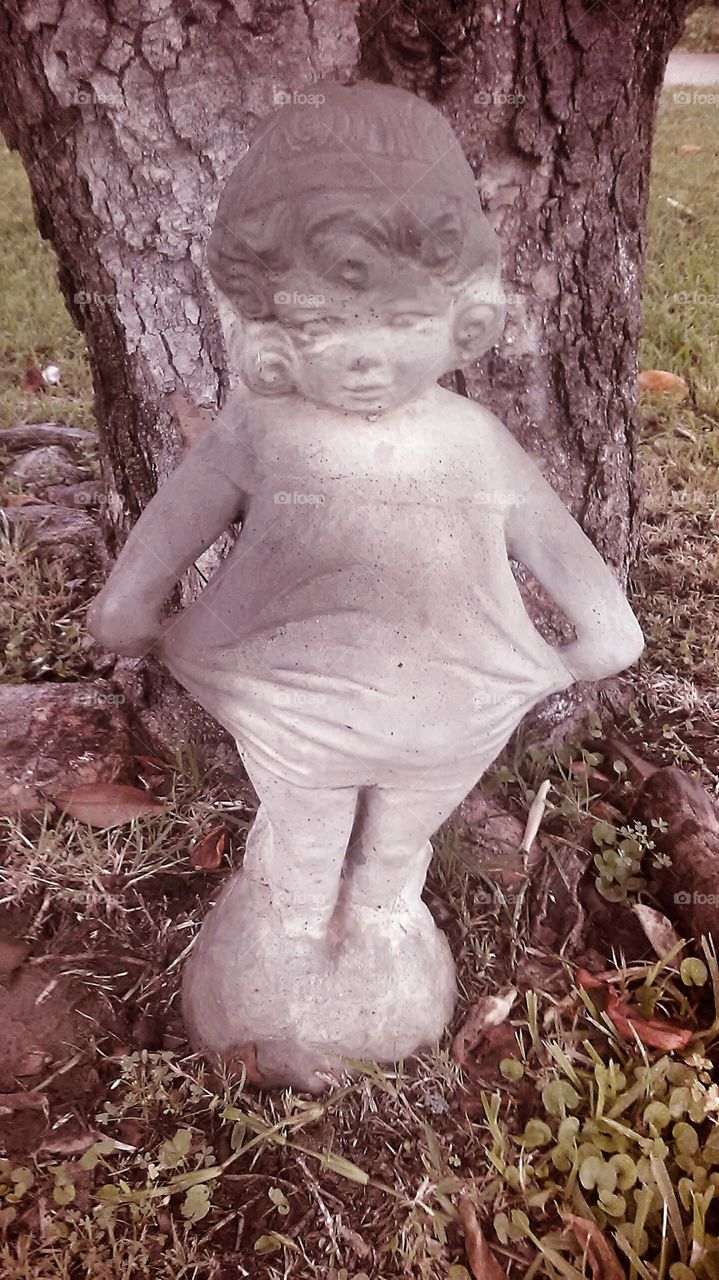 miss ballerina. this figure sits out in our front yard by this tree