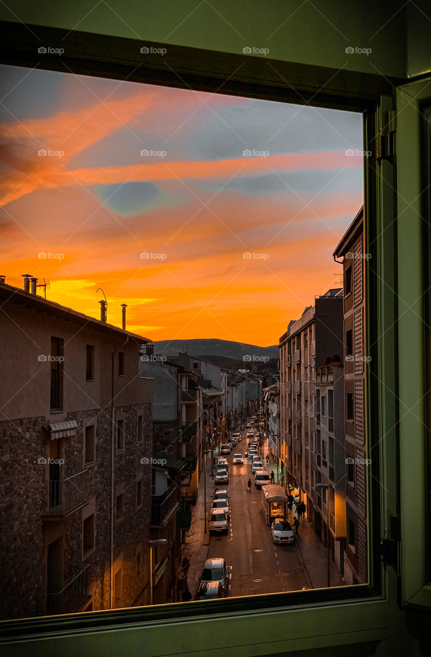 Window view of a cityscape during sunset on the streets 