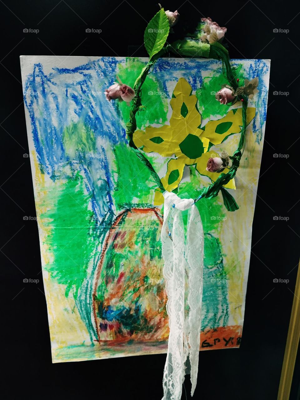 Children's creation: A crayon drawing of a sunflower, surrounded by roses that complement each other, looking beautiful and colorful.