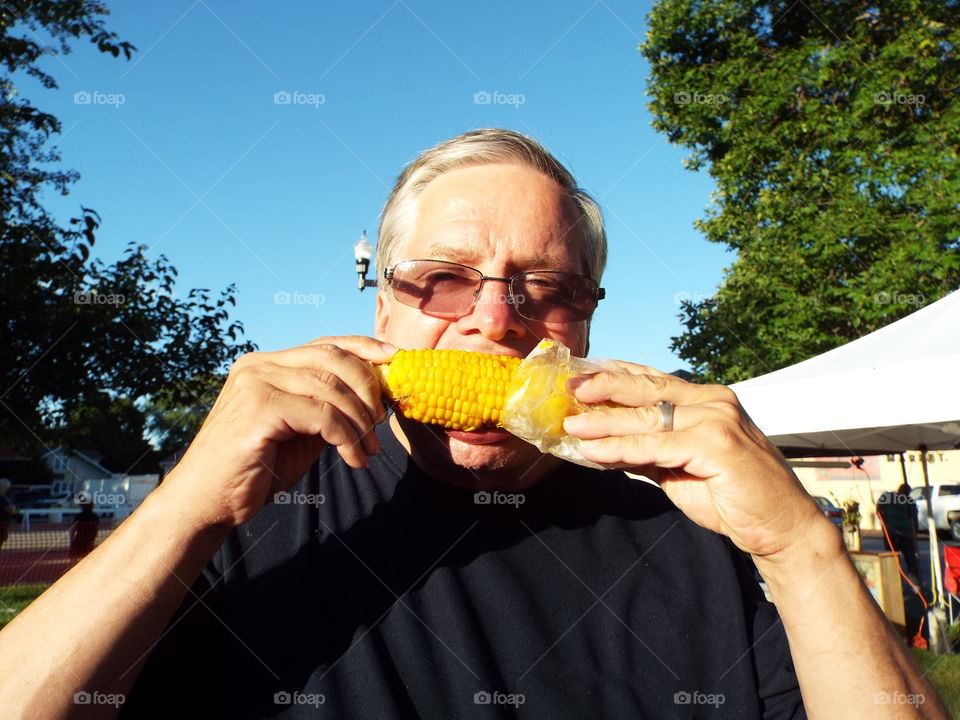 guy eating  corn
