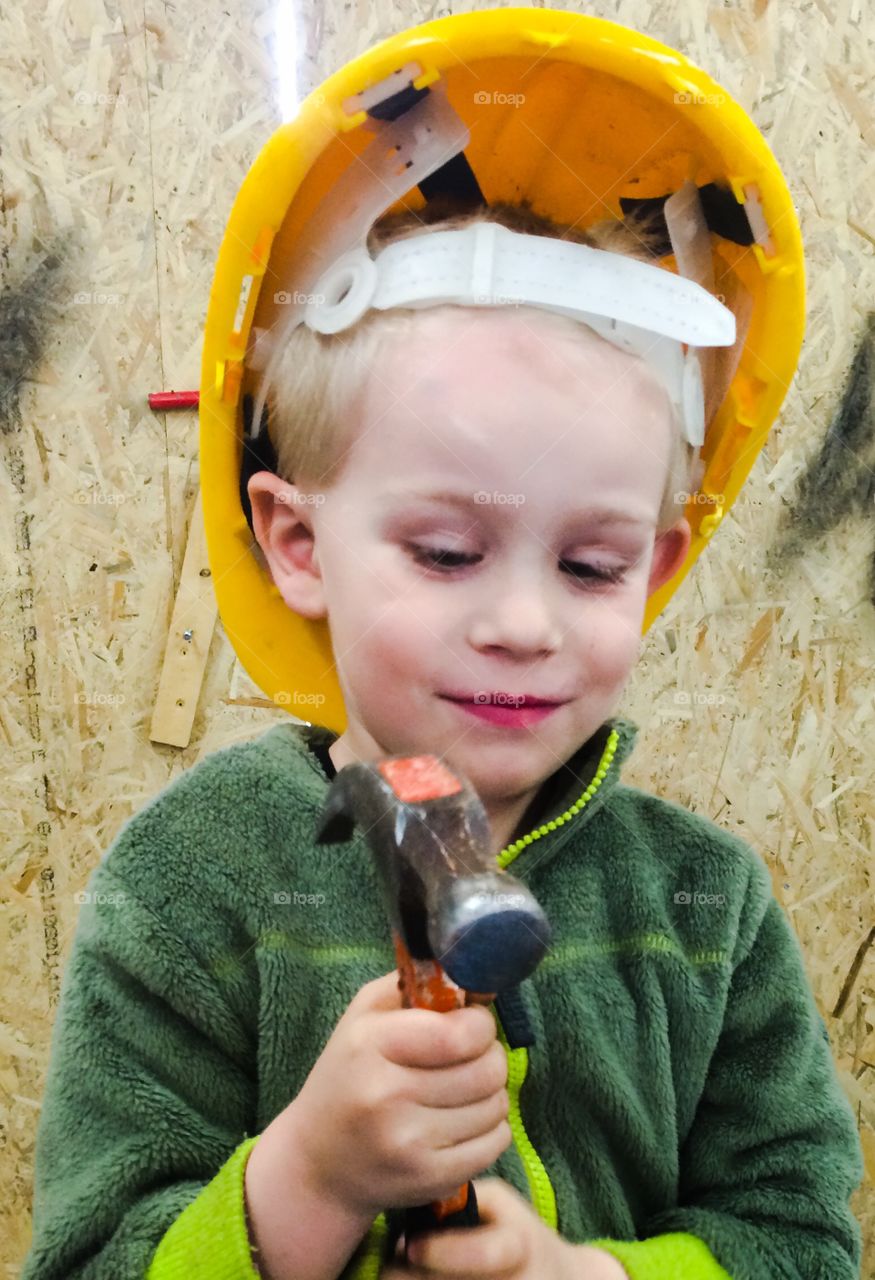 Boy helping out. Boy at work with his father