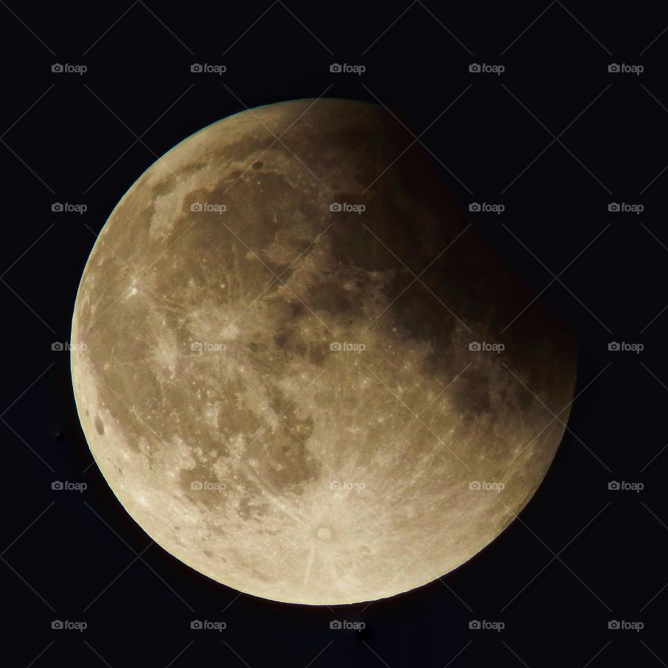 Beautiful stark moon shot of a partial lunar eclipse. Can clearly see the shadow on the moon in detail.