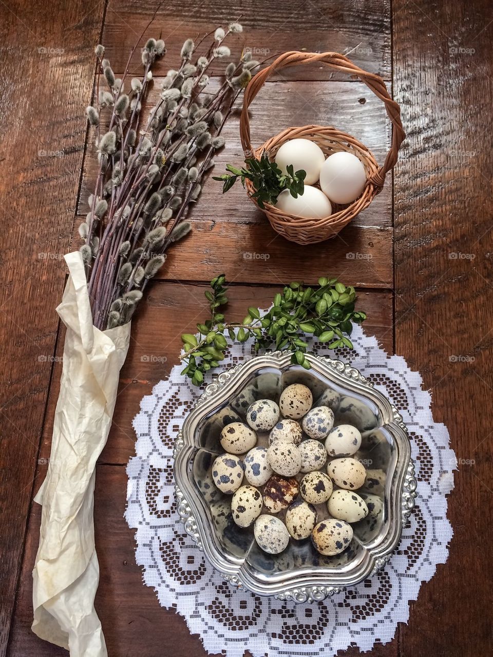 Easter composition of catkins and eggs on wooden table