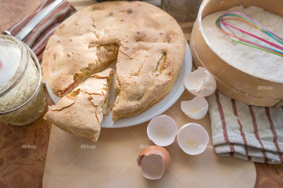 Making homemade puffed apple pie with eggs, sugar and flour.