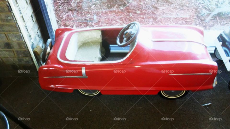 Old red convertible pedal car