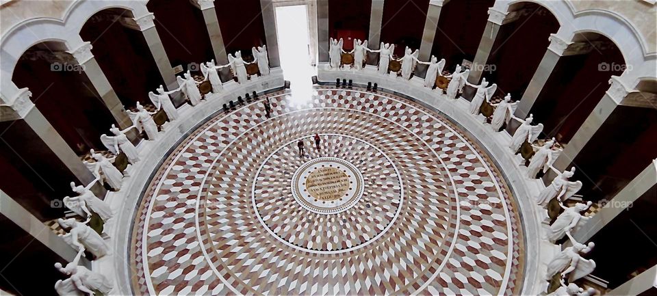 This is “Liberation Hall” by “Kelheim”, Bavaria and its circular mosaic floor with a central inscription commemorating the “Liberation Wars” and Germany’s victory over “Napoleon”. It also has an assembly of large angels. 2024. Hypnotic Productions
