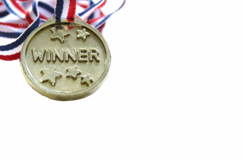 Gold winner medal in the corner of the frame isolated on a plain white background
