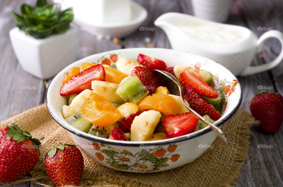 Close-up of a fruits salad with honey