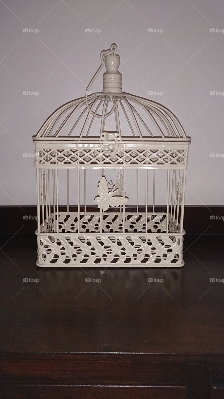 Butterfly Birdcage. A small cream birdcage decorated with butterflies.