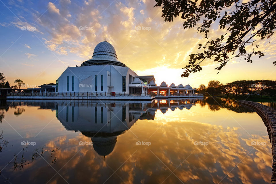 Majestic view of An Nur Mosque during sunrise with beautiful reflections
