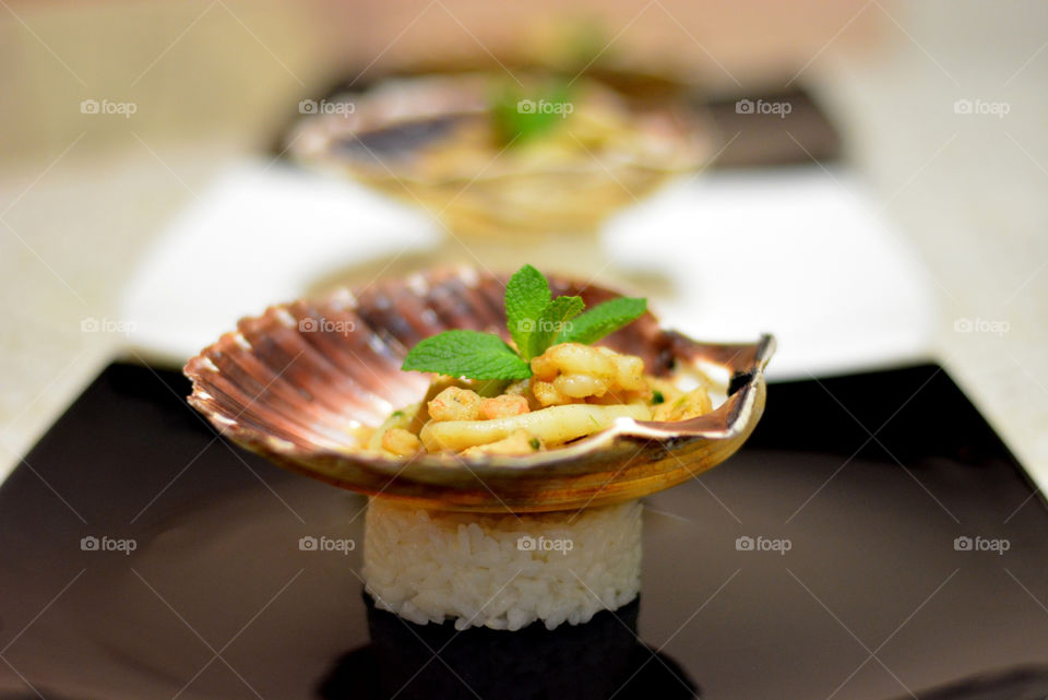 Seafood in scallop shell with rice