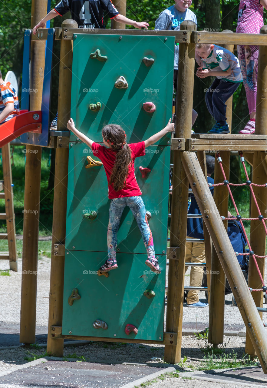 Girl climbing on the wall