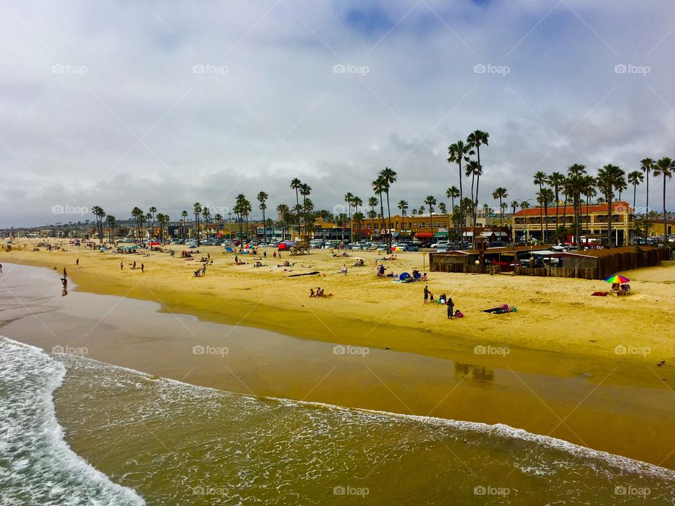 People enjoying the shore at Balboa Peninsula, Newport Beach, California