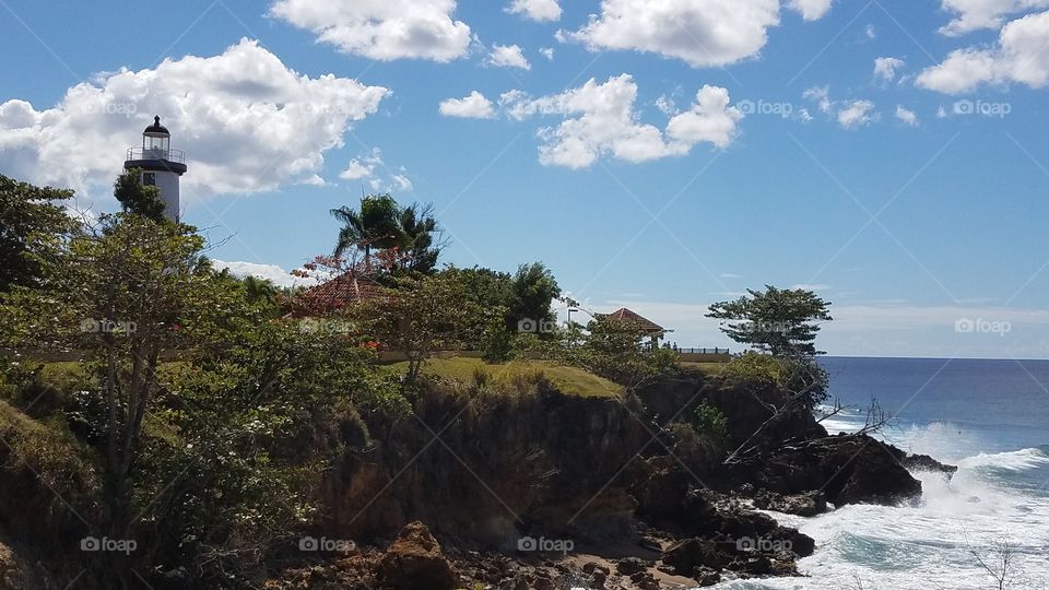 costal lighthouse and a pavilion at a beach side park in Rincon, Puerto Rico
