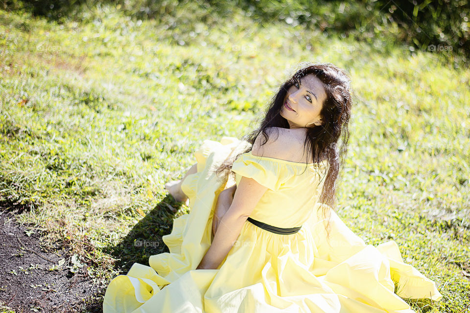 Young woman sitting on grass in park