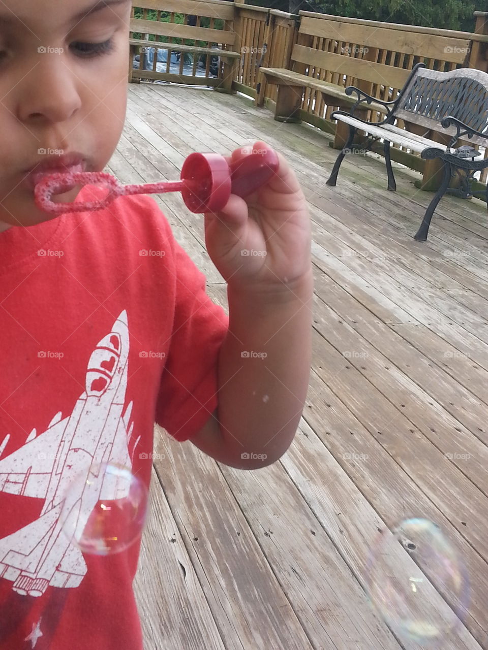 Cute little boy blowing bubbles