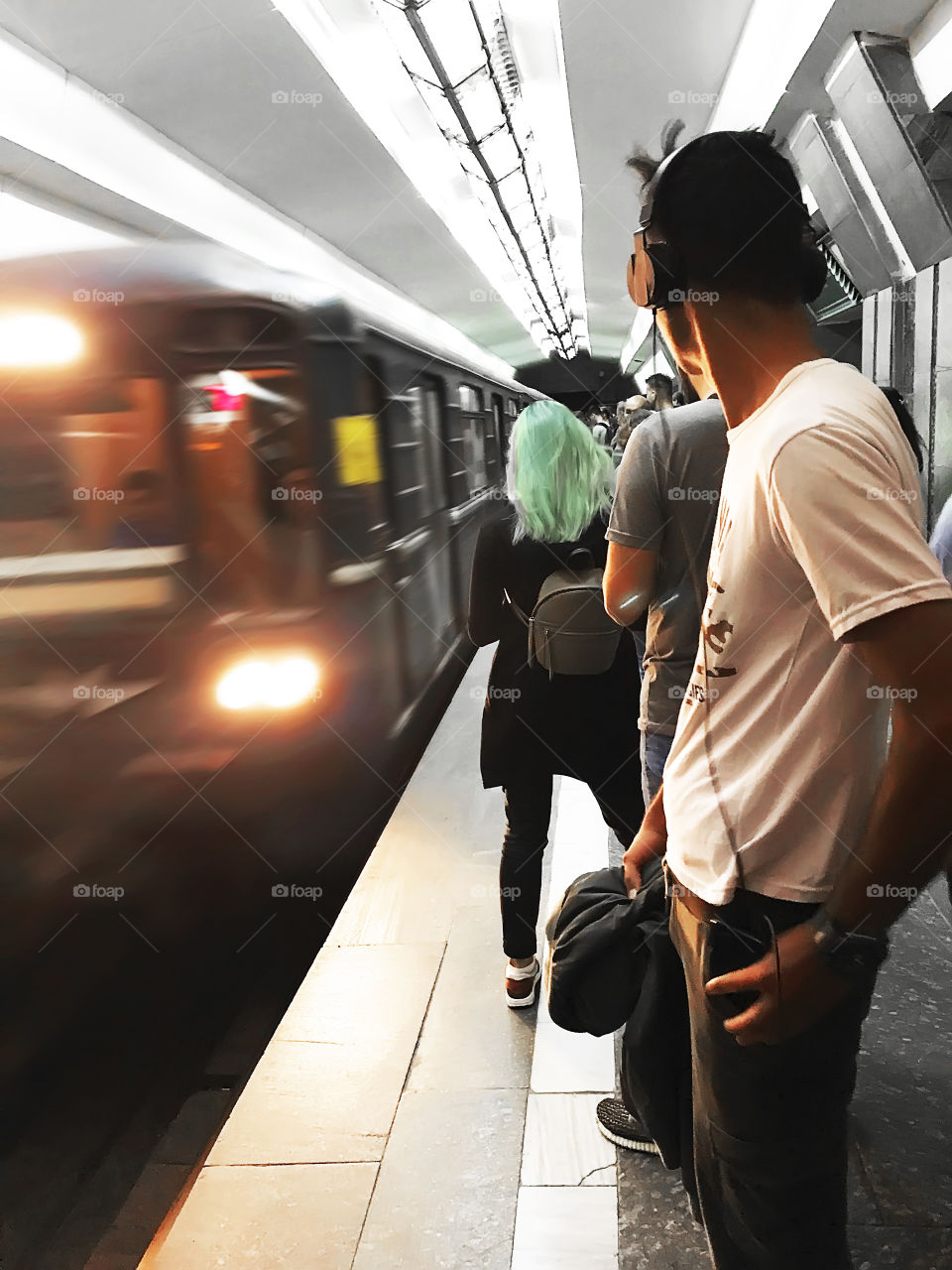 People waiting for a train at city subway station during the rush hour