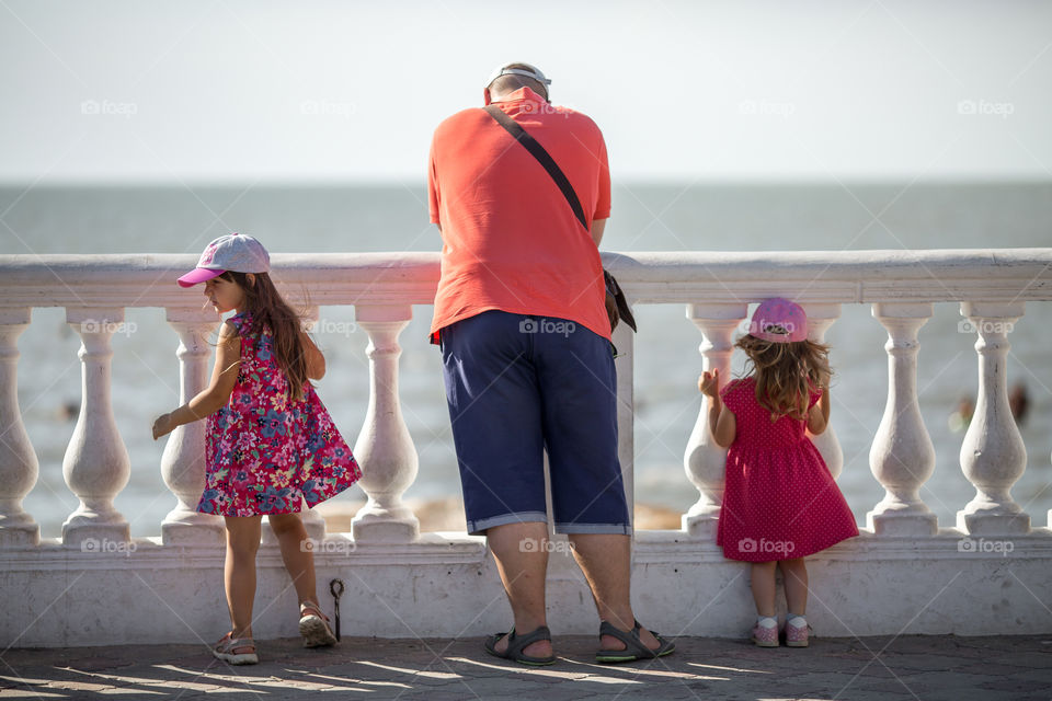 Father with two daughters walking outdoor 