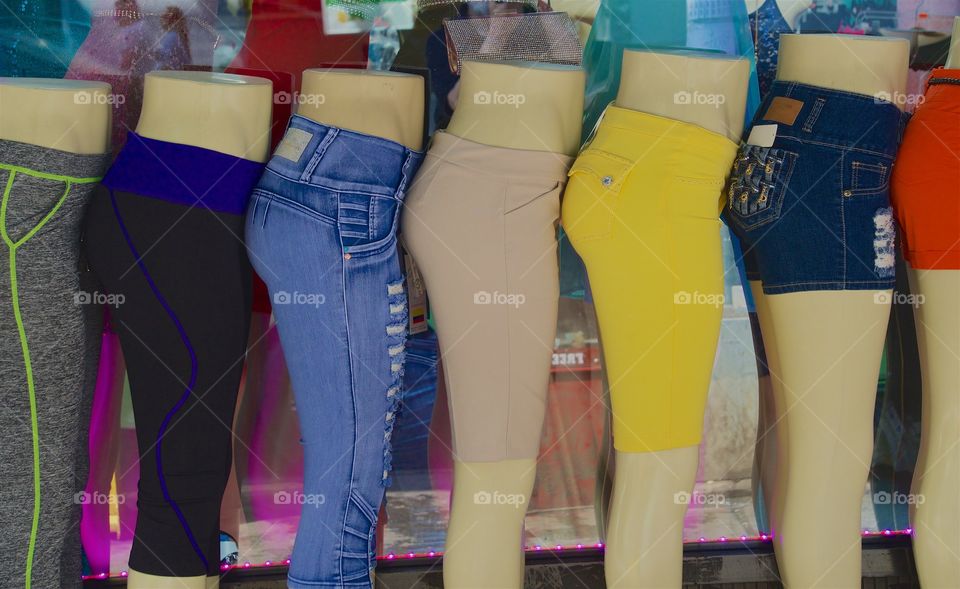 aWoman's pants being displayed on mannequins outside a retail clothing store in New York City.