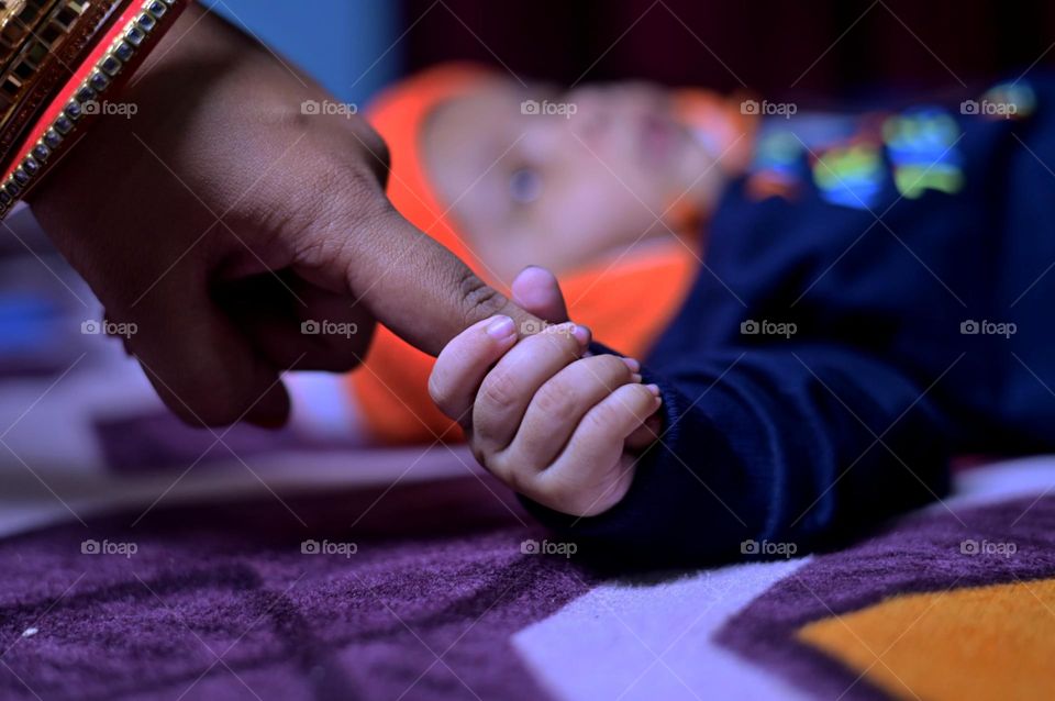 New born baby hand and mom finger