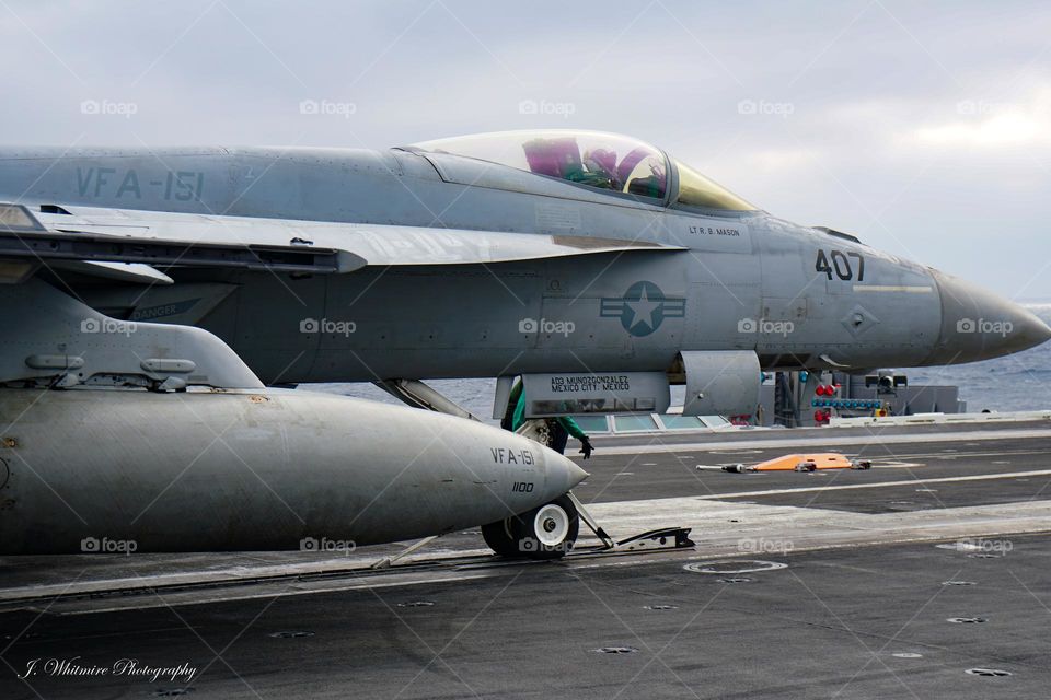 A F/A-18 Super Hornet prepares to launch off a aircraft carrier