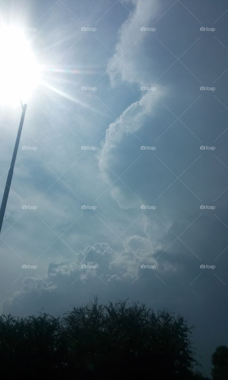 SUN ON CACTUS STICK
Have you ever seen, the sun
Sitting on a Cactus Stick
Shining Brightly, with Rays of
Beams Shining on clouds
Ever so Nicely , that you just
Couldn't help but wonder
To yourself ever so quietly
How Neat that would be if
The sun could do that really
Once in a while, like a once
Or twice a year site to see
You know like an eclipse
Or Meteor shower that comes
To give us a show. the kind
Your mind just cannot let go
To reminisces that we do
Not want to misses . But, this
Picture is just one i got blessed
With in an instant passing by
In our car, that i do not drive
But that is O.K. anyway, because
I was able to snap this picture
While my hubby drove in traffic
That was agitating him like
A broken fixture.